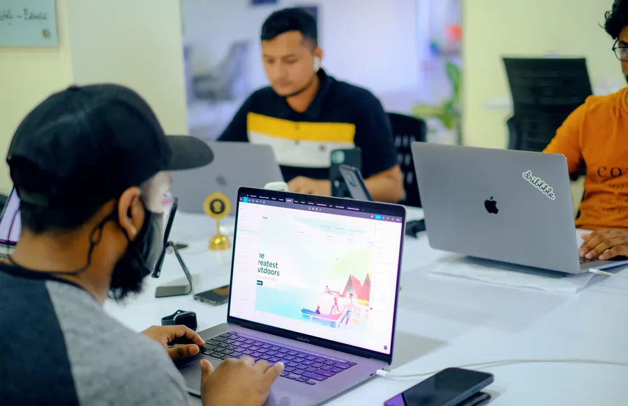 Colleagues working on laptops in a shared office